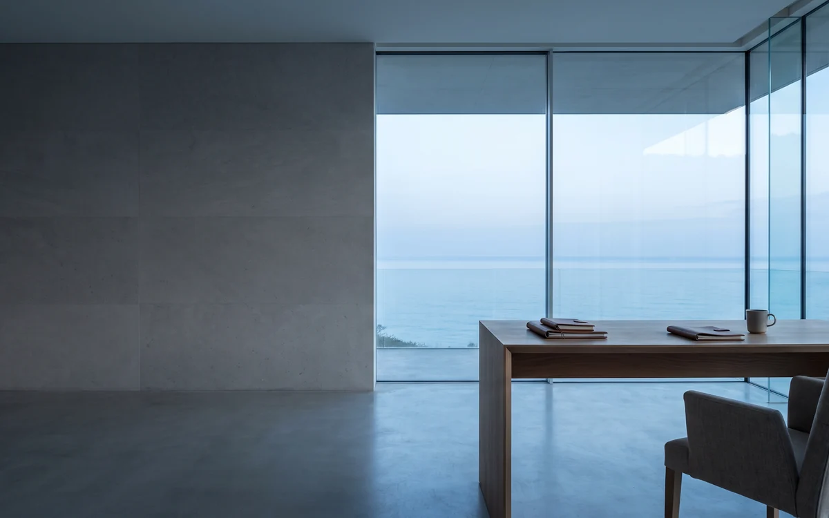 A quiet workspace looking out to a coastal horizon at dawn