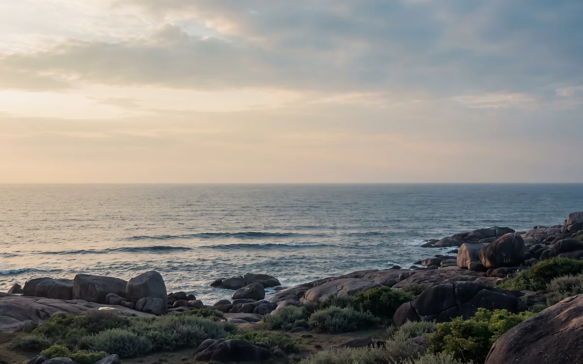 A quiet stretch of rocky coastline at dusk